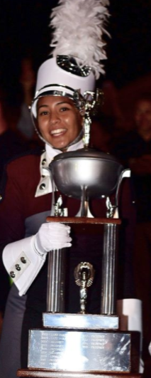 Drum Major Amanda Medina Segura holding the Lake Park trophy