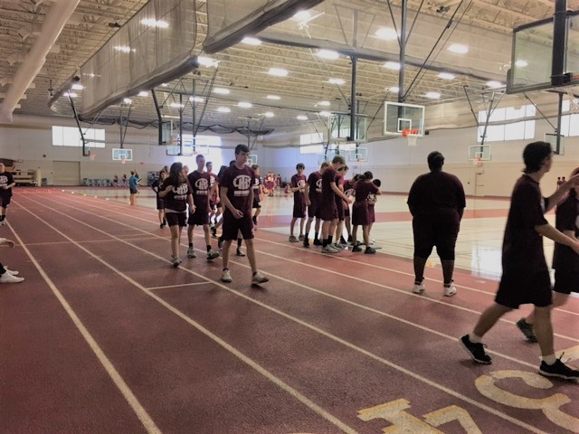 LTHS students walk and run the track to warm up at the start of their P.E. class.
