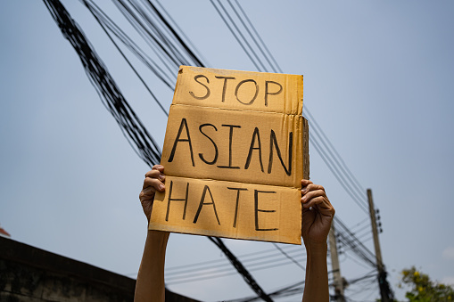 A man holding Stop Asian Hate sign