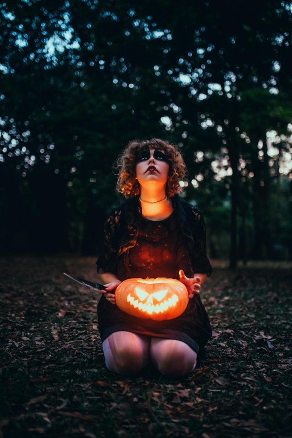 Photo by Matheus Bertelli: https://www.pexels.com/photo/woman-with-halloween-pumpkin-in-park-5477427/