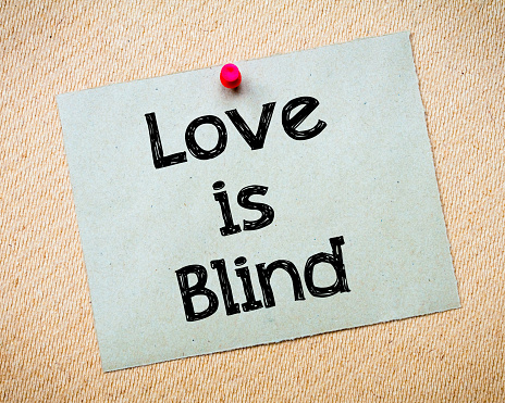 Love is Blind Message. Recycled paper note pinned on cork board. Concept Image