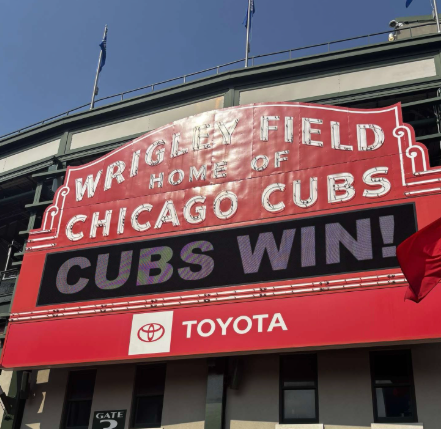 Wrigley Field's iconic red sign displaying Cubs won against the Brewers