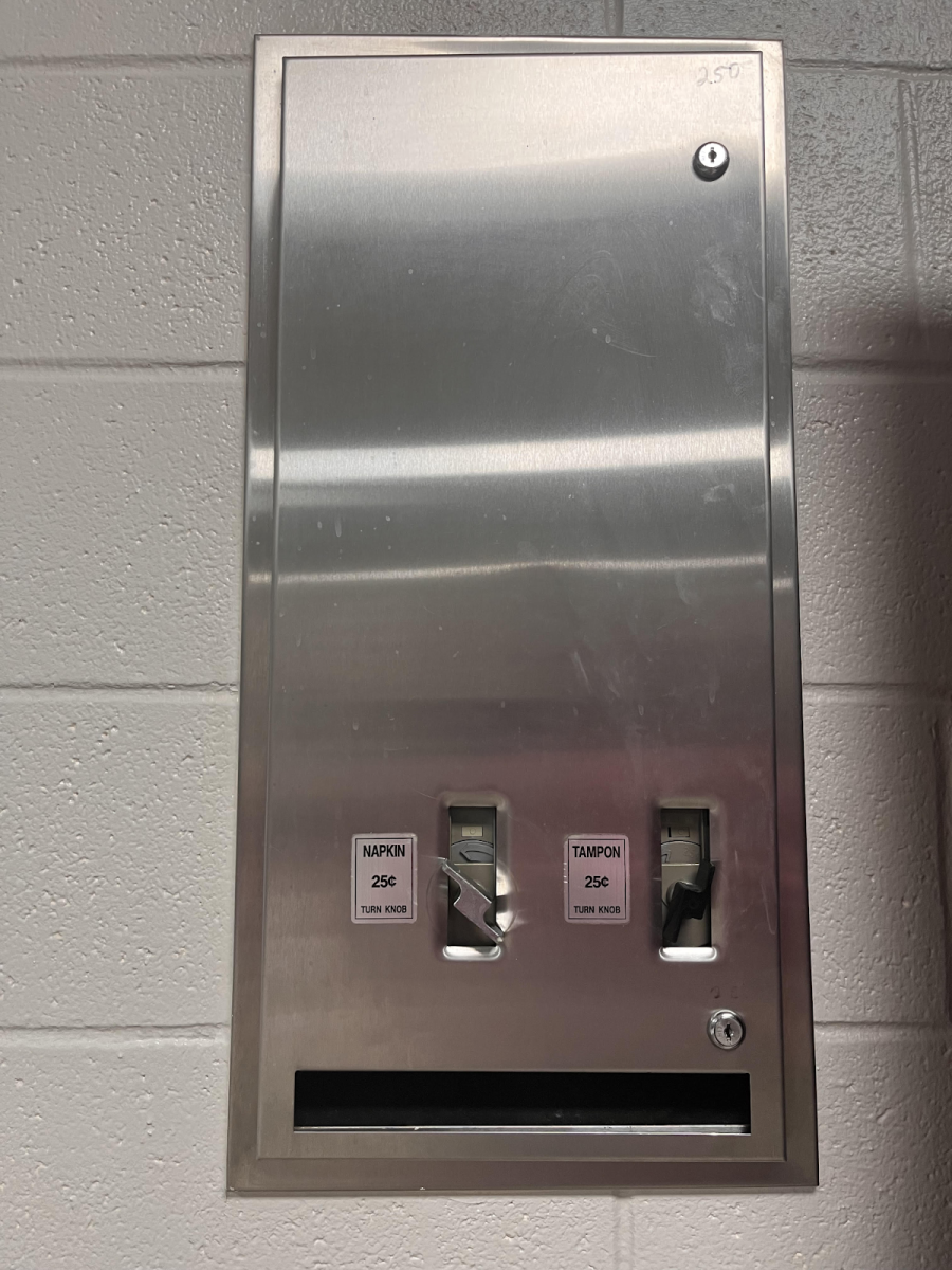 A picture of the empty menstrual product dispenser in a bathroom at LTHS East Campus.