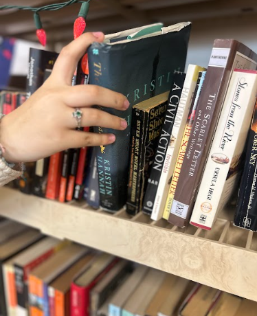 A student grabs a novel off the shelf with a plot worth remembering. 
